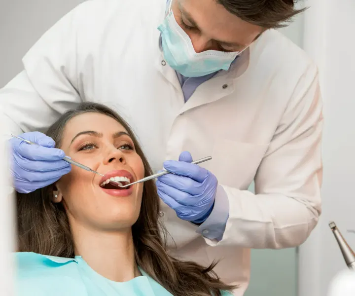 Dentist examining a patient with a mirror and probe